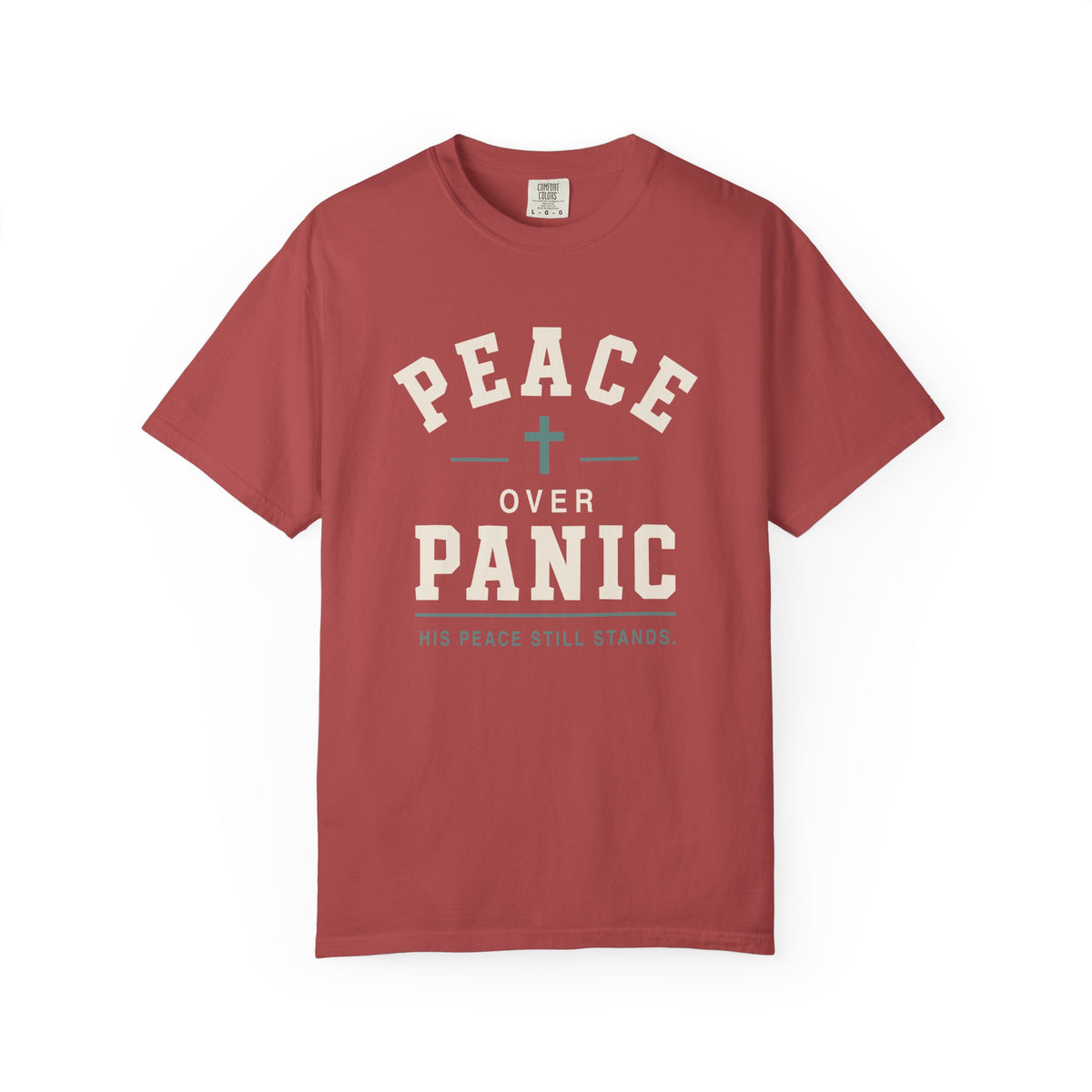 Brick red Christian T-shirt featuring a “Peace Over Panic—His Peace Still Stands” design with a cross on a plain white background.