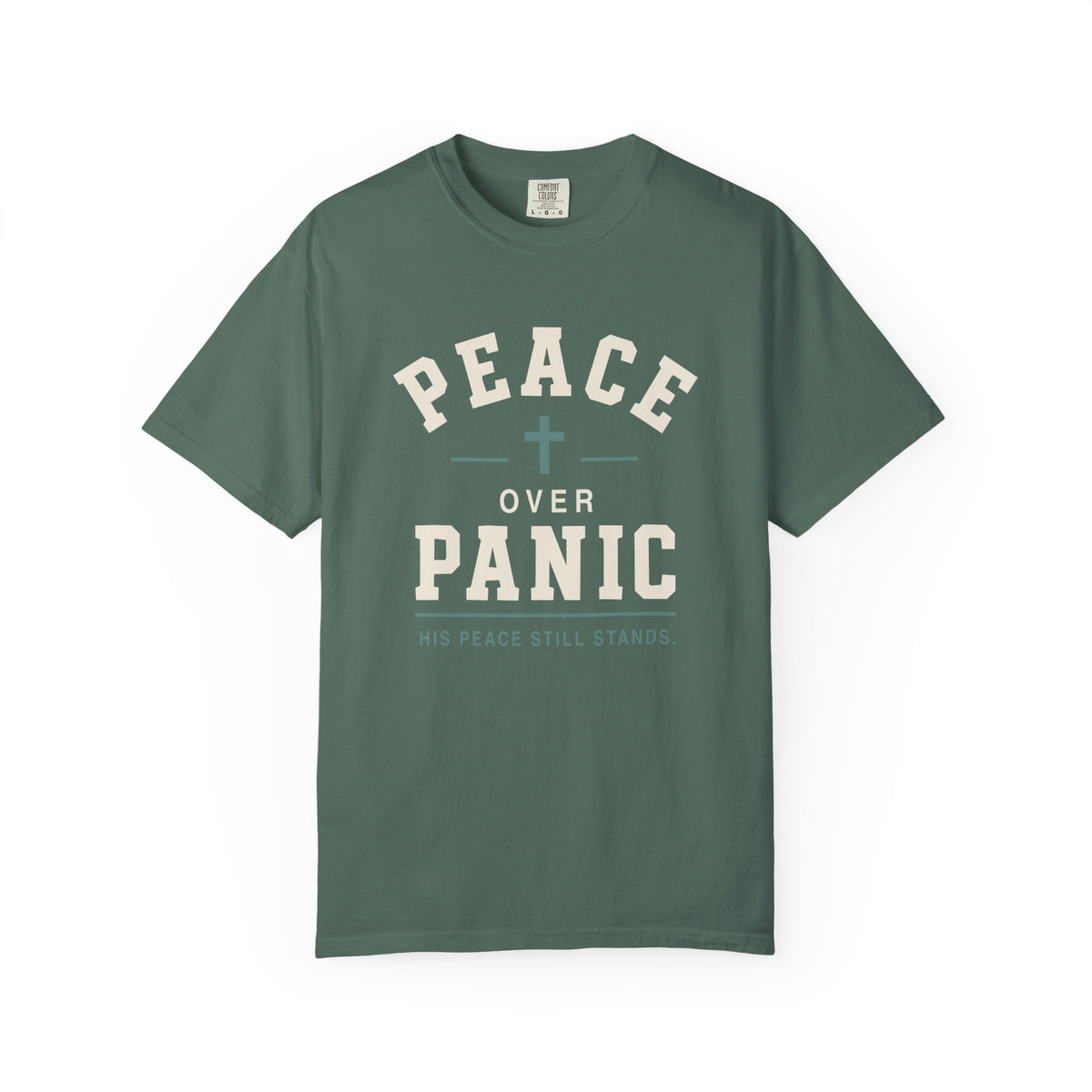 Light green Christian T-shirt featuring a “Peace Over Panic—His Peace Still Stands” design with a cross on a plain white background.