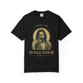 Black short-sleeve t-shirt with a graphic print of Jesus pointing, surrounded by a gold halo and the text 'I WANT YOU TO WALK WITH ME MATTHEW 4:19'.