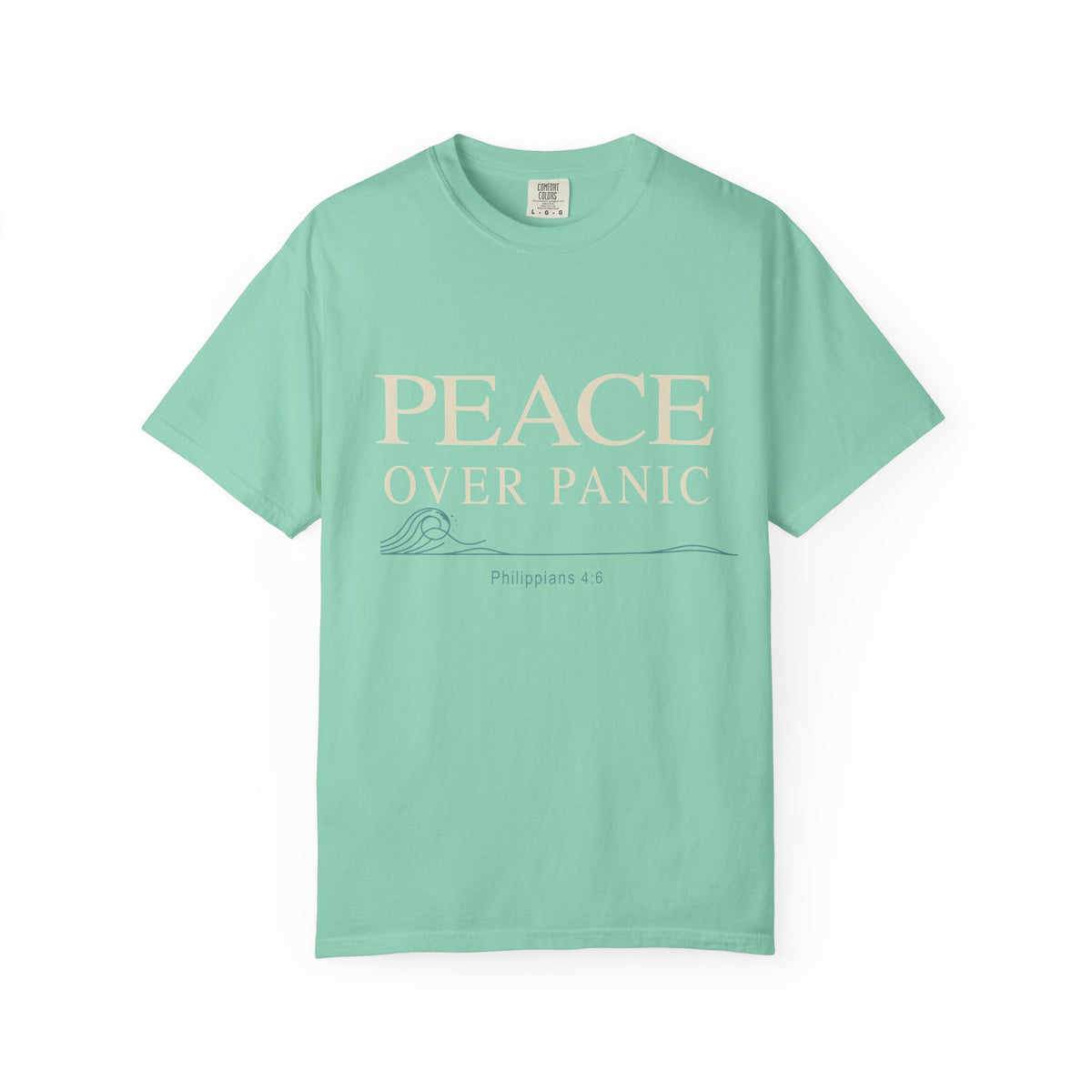 Light aqua Christian T-shirt featuring a “Peace Over Panic” design with a wave and Philippians 4:6 on a plain white background.