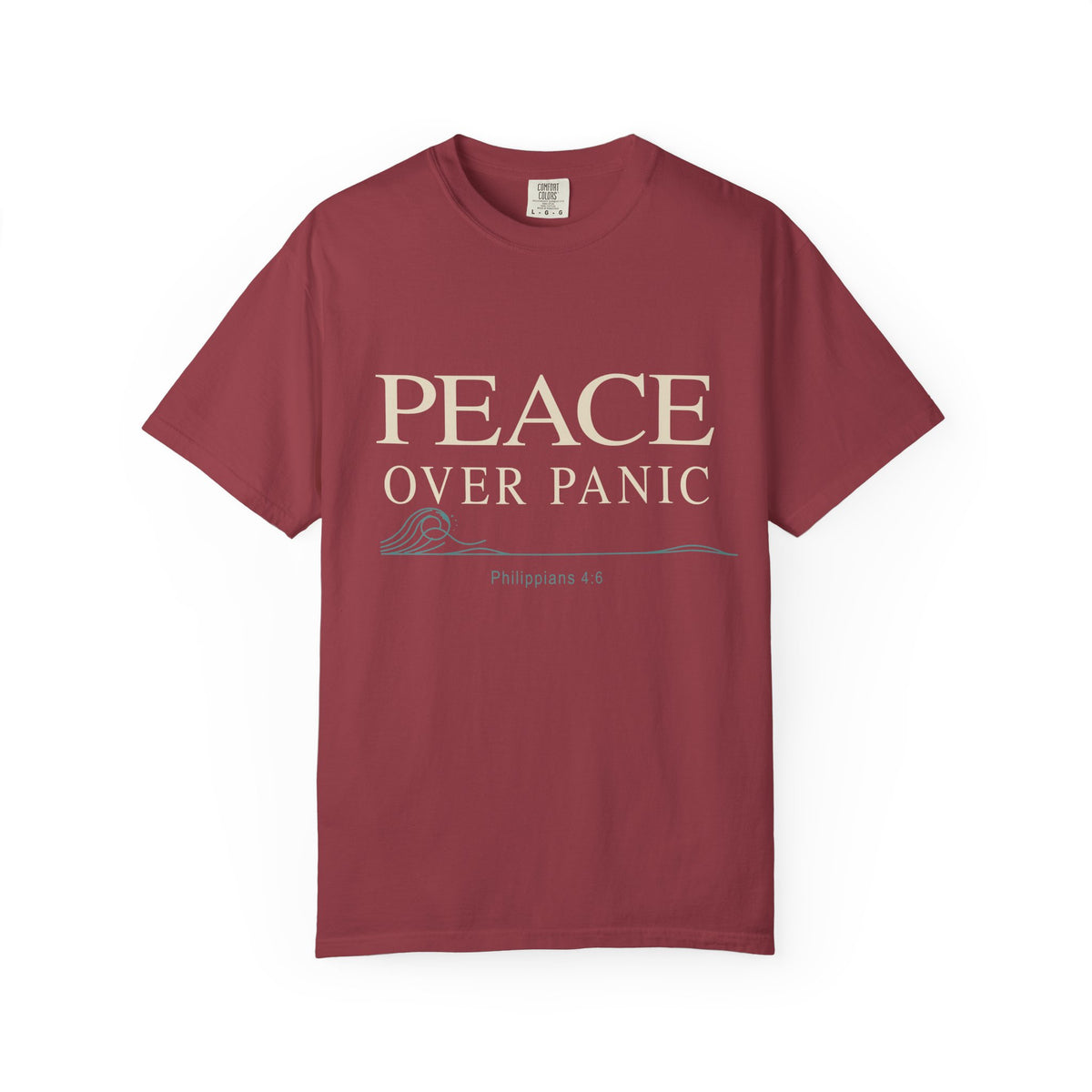 Brick red Christian T-shirt featuring a “Peace Over Panic” design with a wave and Philippians 4:6 on a plain white background.