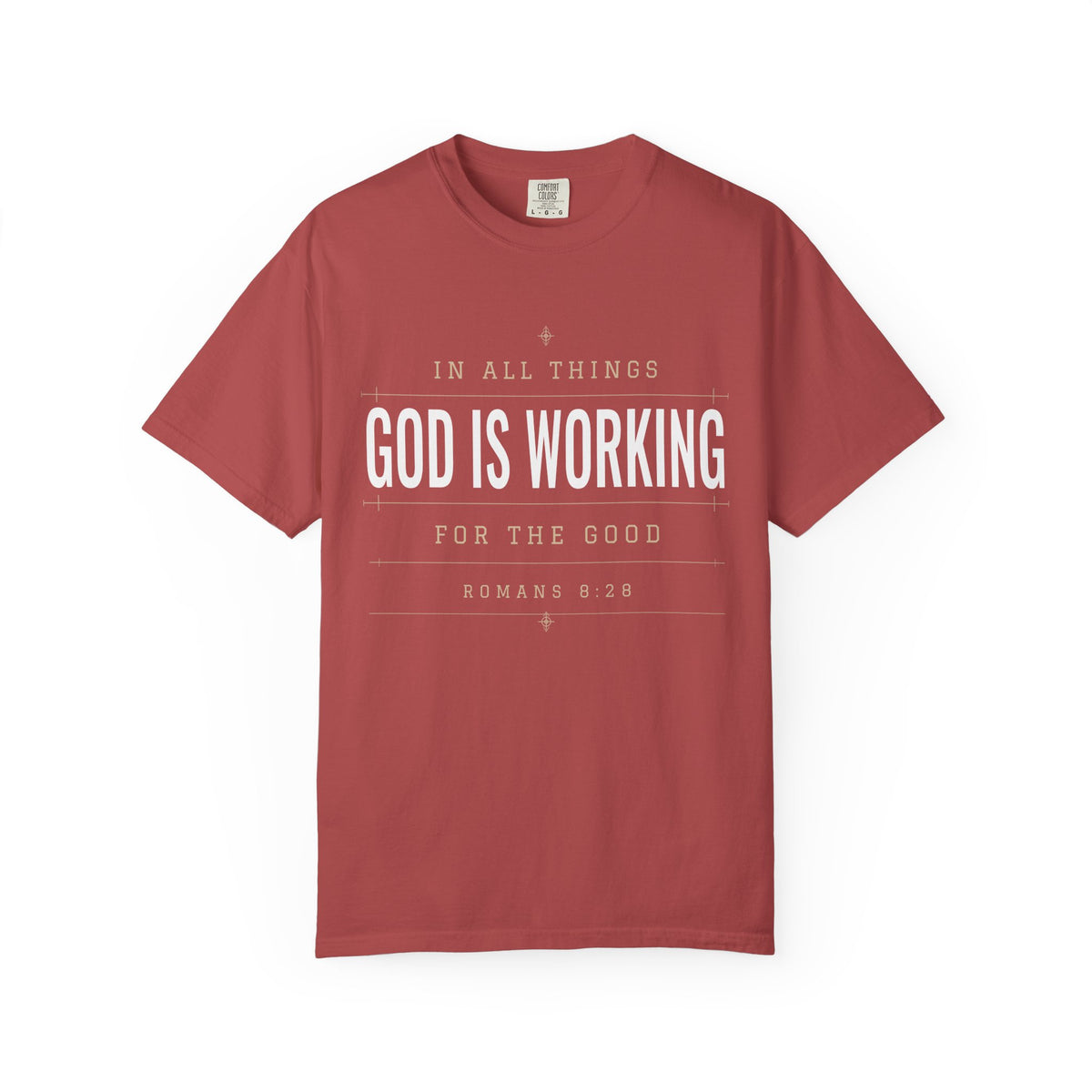 Brick red Christian T-shirt featuring “In All Things, God Is Working for the Good” with Romans 8:28 on a plain white background.