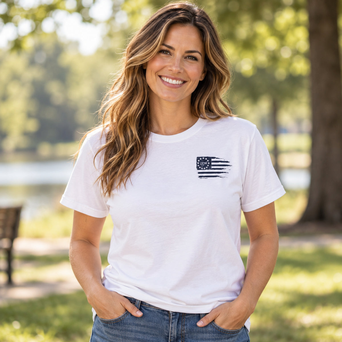 Woman wearing white Christian crew-neck T-shirt with small distressed 1776 American flag graphic on left chest.