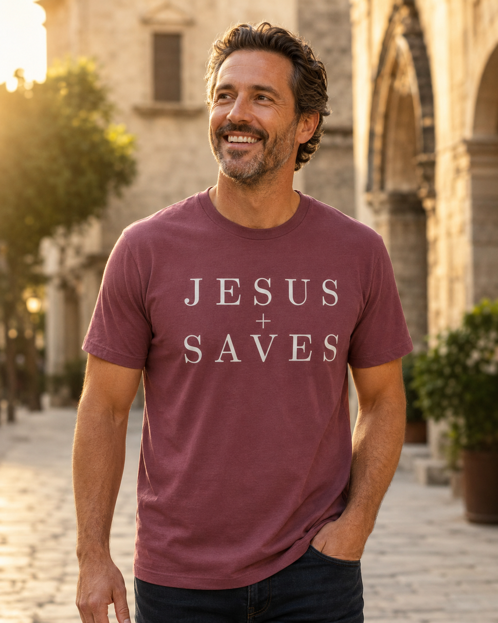 Man wearing maroon Jesus Saves shirt on a sunlit stone walkway