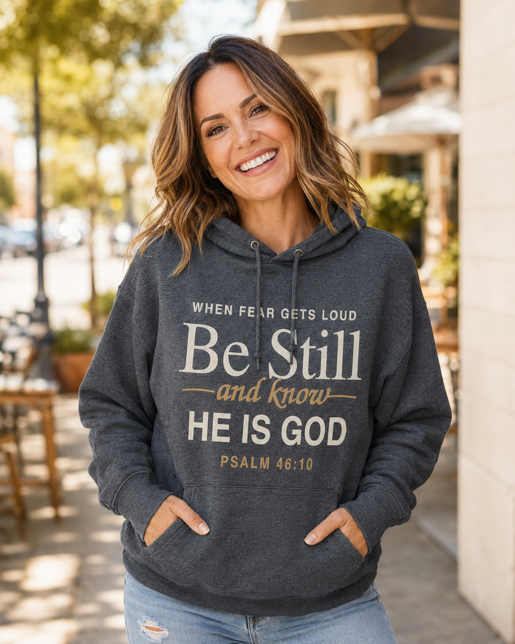 Woman wearing Psalm 46:10 Be Still and Know Christian hoodie
